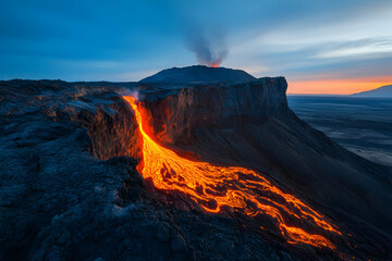 Fototapeta premium A beautiful mountain in the middle of an erupting volcano, with lava flowing down its side, glowing orange and red against the dark blue sky.