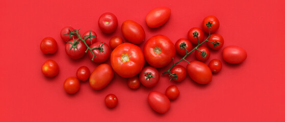 Fresh ripe tomatoes on red background