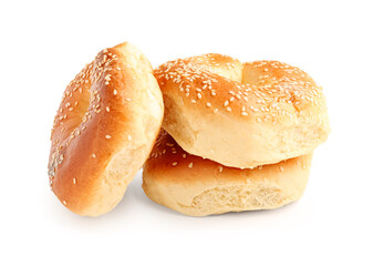 Tasty bagels with sesame seeds on white background
