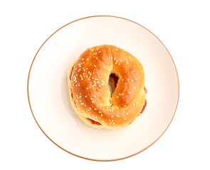 Plate of tasty bagel with strawberry jam on white background