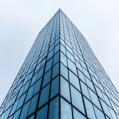 Fototapeta premium Modern skyscraper with reflective glass facade towering against a cloudy sky