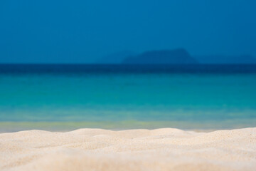 Beach sand background for summer vacation concept. Beach nature and summer seawater with sunlight light sandy beach Sparkling sea water	
