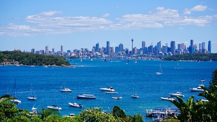 Sydney skyline from the coast with boats in the foreground
