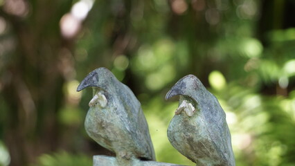 Wooden bird sculptures at an arboretum 