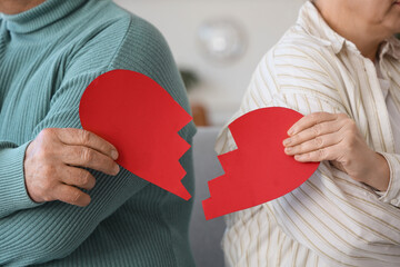 Mature couple with broken heart at divorce lawyer's office, closeup
