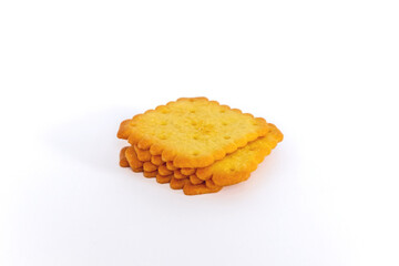 A stack of biscuit crackers in a square shape on a white background
