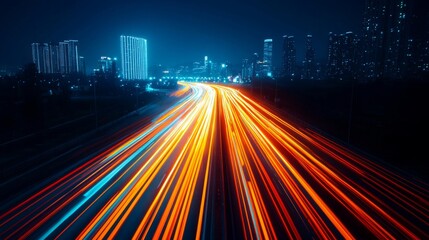 Fototapeta premium Vibrant night cityscape with light trails from moving vehicles on highway