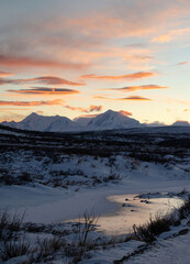 Bright orange clouds above mountains in Alaska