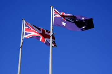 The British Union Jack and Australian flag flying together