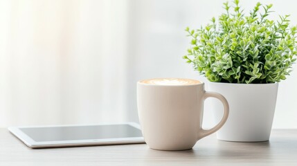 Obraz premium Morning Ritual: A tranquil scene featuring a cappuccino, tablet and plant, evoking a sense of serenity and gentle start to the day.
