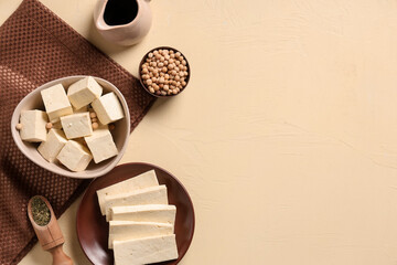 Tasty tofu cheese on beige background with space for text