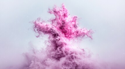 Fototapeta premium Vibrant pink powder explosion bursting against a clean light grey background in a studio setting.