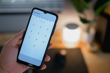 Person entering pin code to unlock the phone's screen 