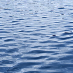Serene Ocean Surface Texture with Ripples and Reflected Sunlight creating calming peaceful atmosphere.