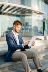 Young business man leader entrepreneur, professional manager holding digital tablet computer