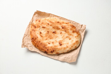 Baking paper with tasty lavash on white background