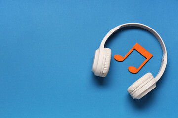 Composition with headphones and decorative music notes on blue background
