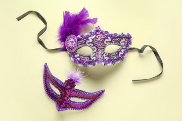 Beautiful purple carnival masks on beige background