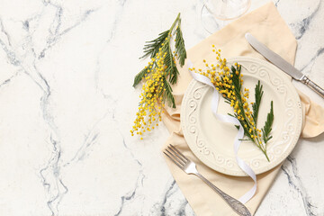 Beautiful table setting with mimosa flowers on white background