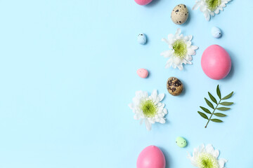 Composition with flowers and Easter eggs on blue background