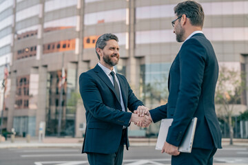 Celebrate business partnership. Two businessmen partner celebrating business deal. Successful partnership in business deal. Businessmen dealing outdoor. Partnership success. Corporate hiring