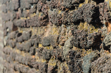 A corroded stone wall of a fort in Kerala, India.
