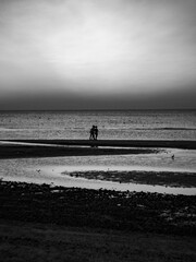 man walking on the beach at sunset