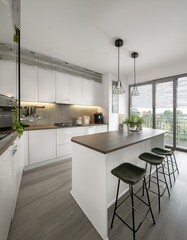 White kitchen interior with bar and table