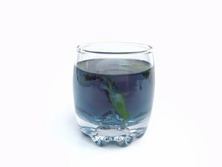 Boiled butterfly pea flower water in a glass on white background. Healthy drink lifestyle 