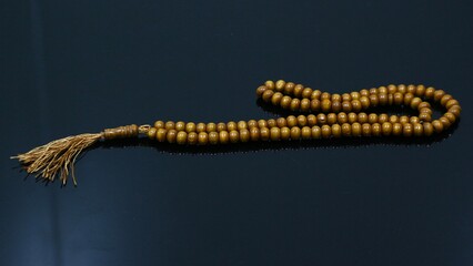 prayer beads made of wood on a black background