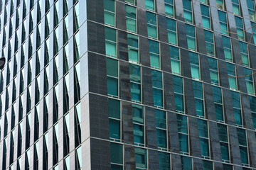 Modern Glass Office Building with Reflective Windows and Geometric Patterns