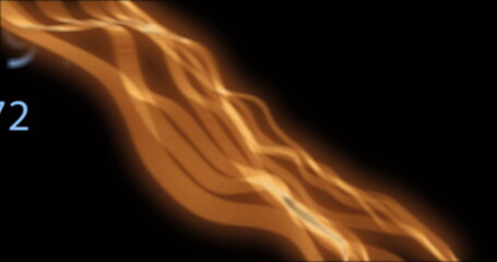Image of glowing orange light trails and numbers moving on black background