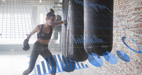 Image of diagrams over caucasian woman punching boxing bag at gym