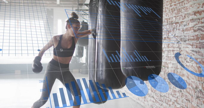 Image of diagrams over caucasian woman punching boxing bag at gym