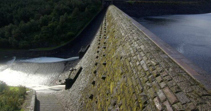 Extra Wide shot of the downstream slope face of the Caban Coch Dam with water discharge release