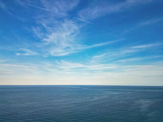 Skyscape with peaceful sea horizon. Calm horizon view at sea nature. Romantic summer vacation view on seascape. Sea horizon view. Cloudy sky and seascape at summer vacation