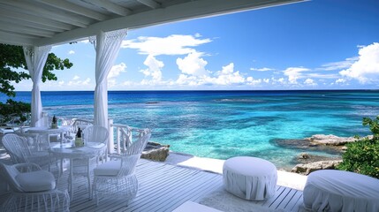 A stunning ocean view from a luxury resort, with white outdoor furniture providing a perfect spot for guests to enjoy the serene and scenic beauty.