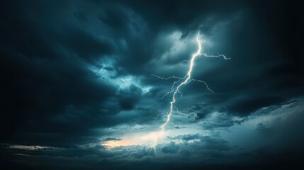 A dramatic silver lightning bolt cutting through a dark stormy sky, illuminating the clouds.