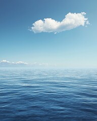 Obraz premium A vast, calm sea under the blue sky, with a white cloud in sky. The water is deep and serene, reflecting the clear sky above it. 