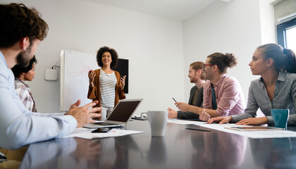 Happy african american female leader holding negotiations meeting with friendly diverse colleague