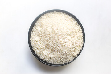 a bowl of raw rice on a white background