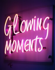 Vibrant neon sign reading Glowing Moments in bright pink, mounted on a sleek panel, casting a soft glow, evoking nostalgia, creativity, and storytelling in photography