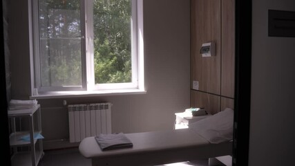 Empty massage room ready for procedure in spa with a comfortable bed, offering a calm and professional ambiance. Concept of health care, relax rest, health center 