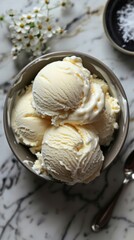 An inviting bowl of classic vanilla ice cream, showcasing smooth and creamy textures against a marble backdrop.