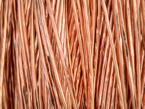 Aligned copper wires displaying consistent patterns and detailed textures in a parallel arrangement.