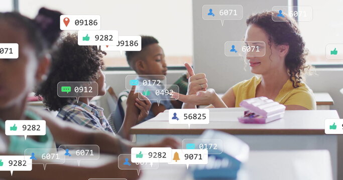 Image of media icons over diverse schoolchildren learning with female teacher - Powered by Adobe