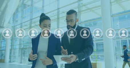 Image of people icons over caucasian businesspeople networking