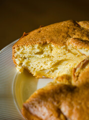 Fluffy apple cake slice on plate, warm dessert , golden crust, rustic charm. High quality photo