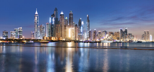 Naklejka premium Panorama of Dubai Marina at night with scyscrapers skyline, UAE