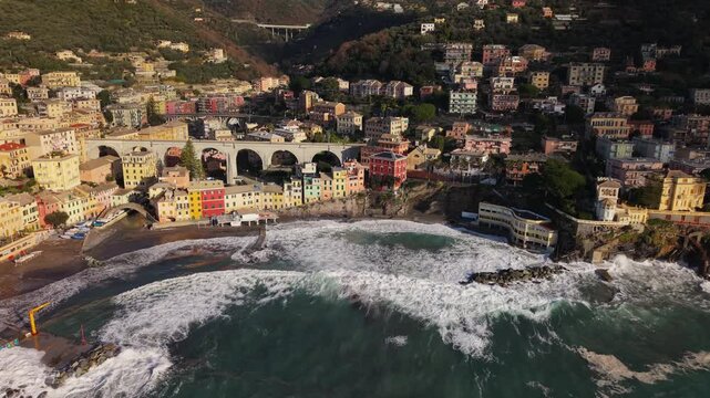 Bogliasco, liguria, showcasing vibrant buildings and crashing waves, aerial view